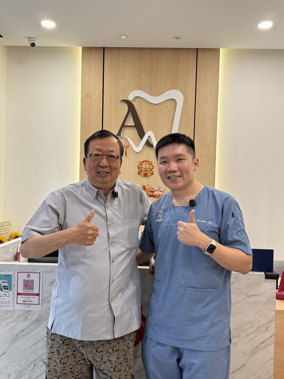 A happy patient at A M Dental reception