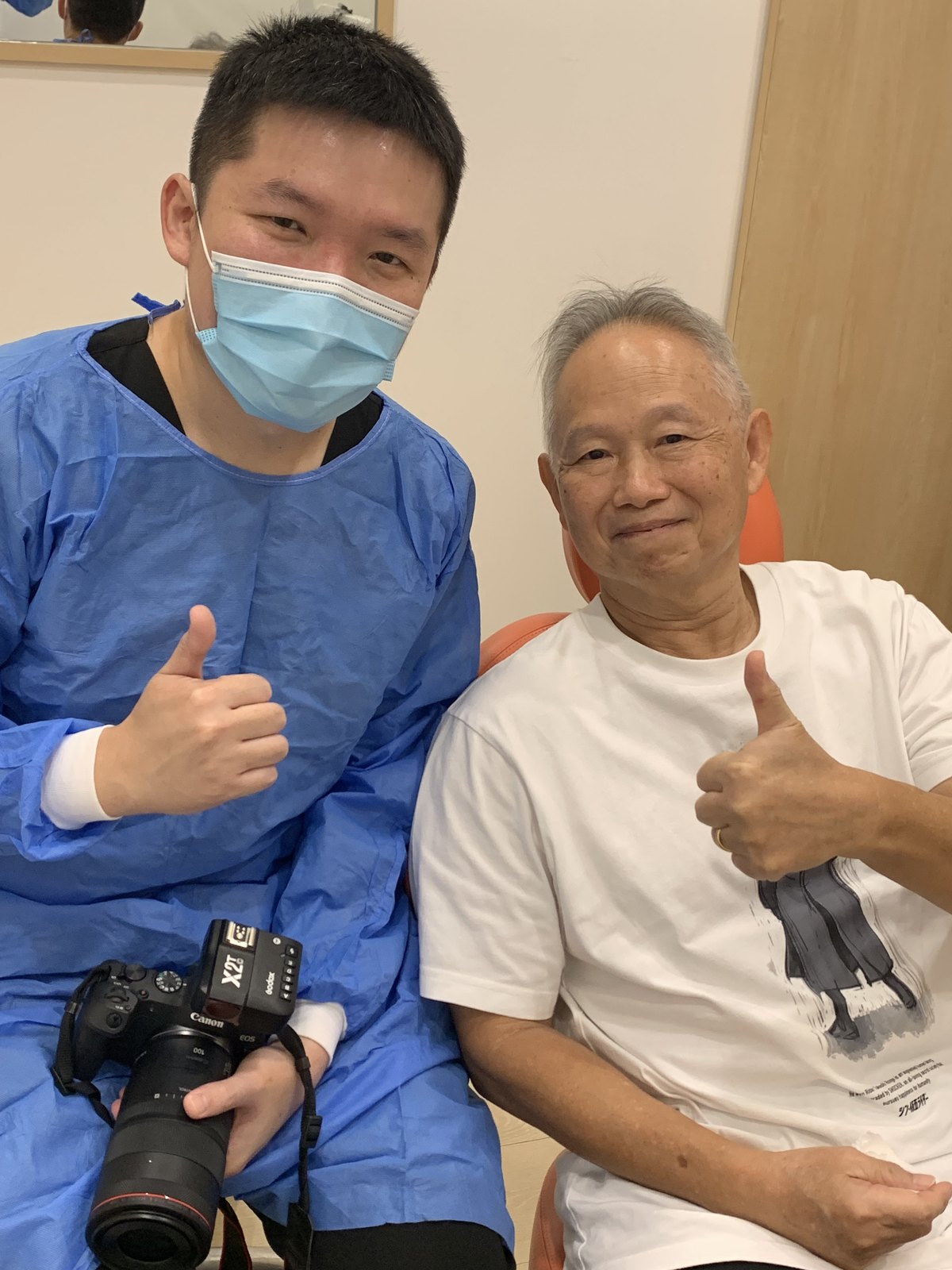 A senior patient giving a thumbs up after treatment at A M Dental