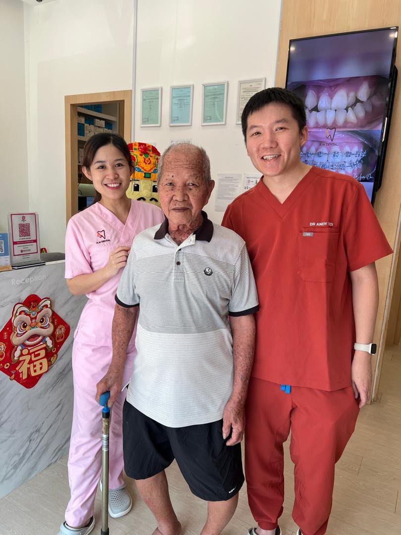 A senior patient with the A M Dental team