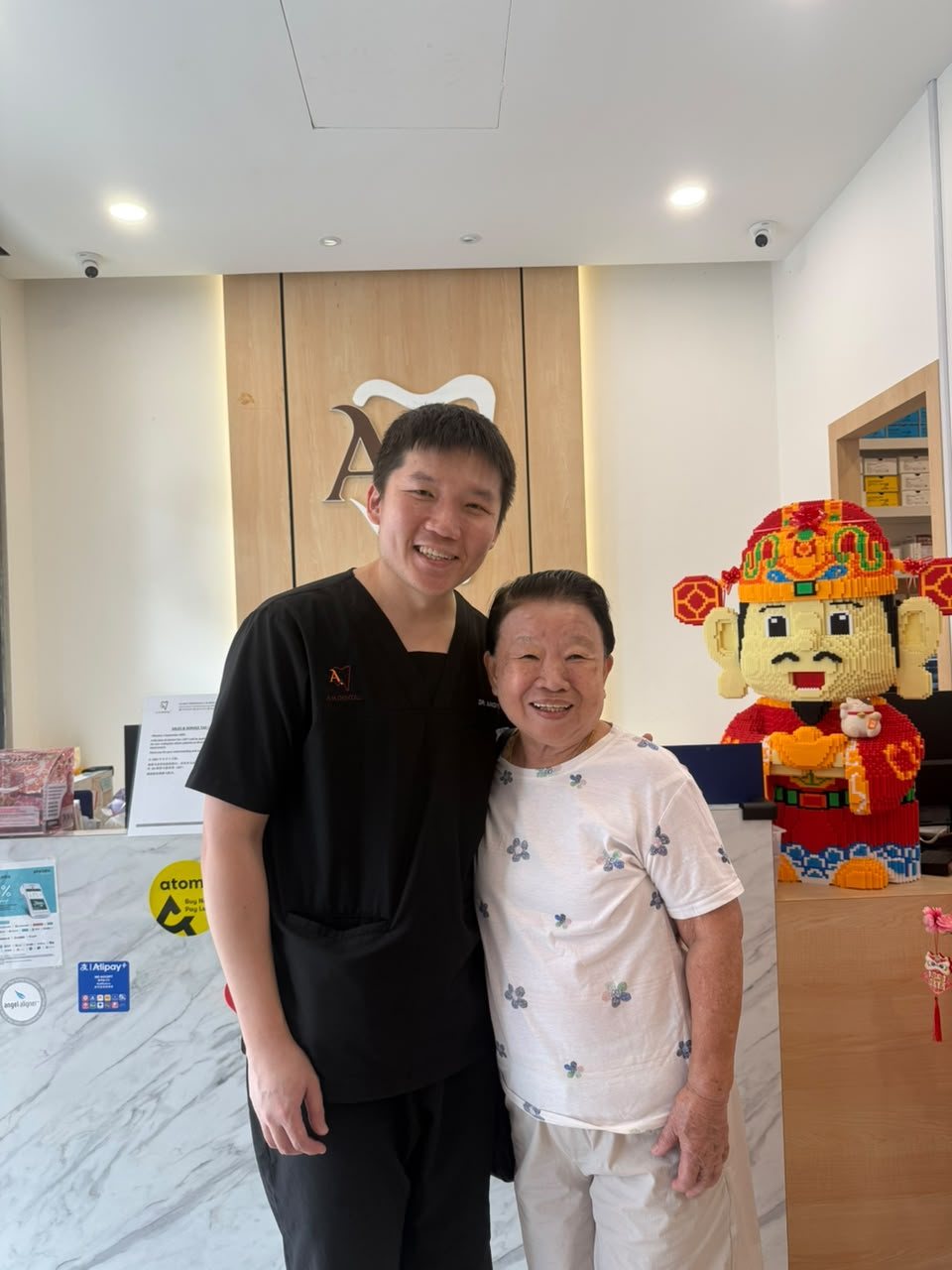 A senior patient with a dentist at A M Dental