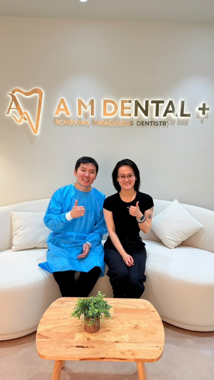 A patient with the A M Dental team after completing treatment
