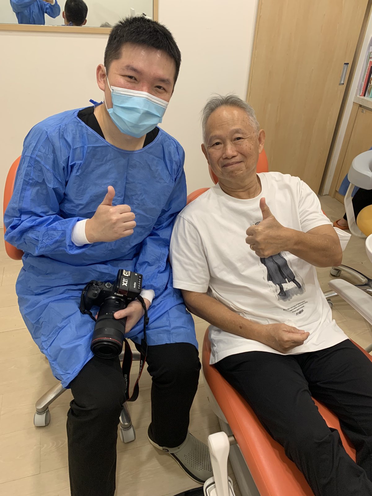 A patient giving a thumbs up in the treatment room